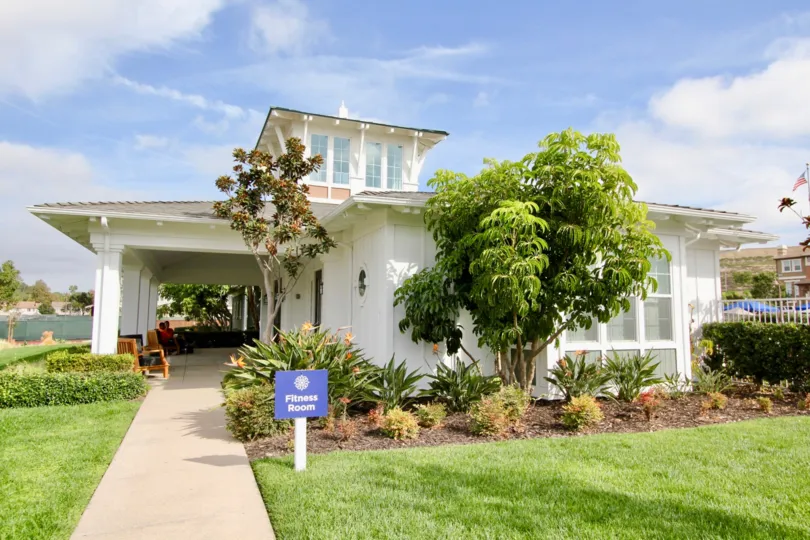 Blue sign on a white post in front of a home at St Cloud at Ocean Ranch in Oceanside CA