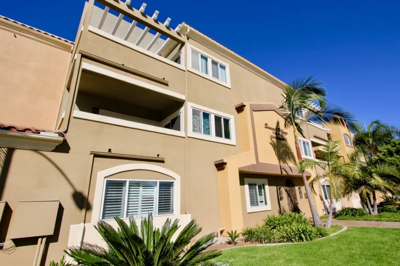 In the Summit Village community of Oceanside, CA a tan complex is made of cement.