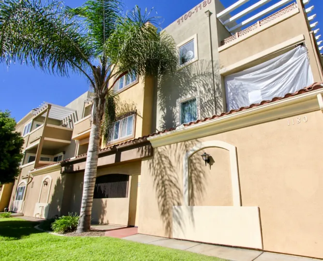 Beautiful sunny day overlooking Smmit Village windows and palm trees.
