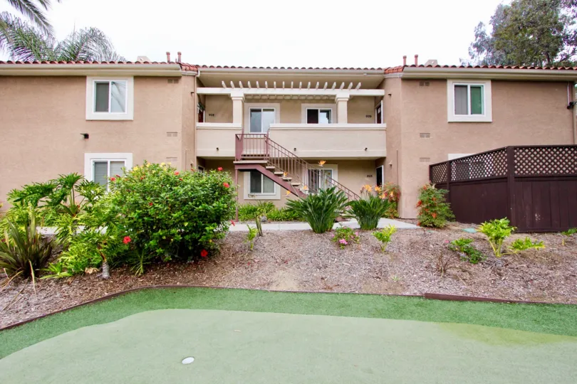 THE HOUSE IN THE BLUFFS WITH THE STEPS, BALCONI, STEEL WALL, LAWN, BEAUTIFUL FLOWERS.