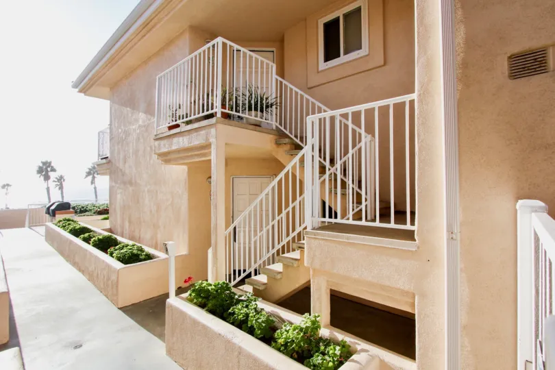 Outside look of a building with iron stair case from ground to first floor in Villa Pacific.