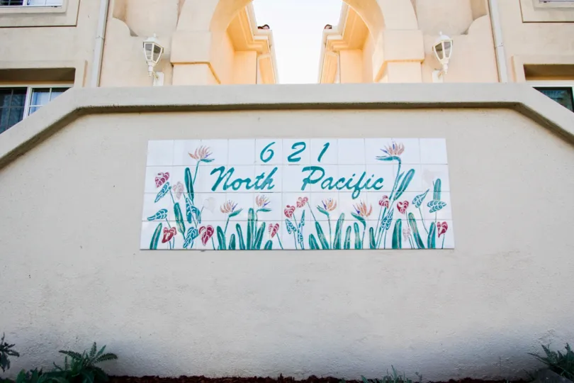 A sunny day in the area of Villa Pacific, welcome sign, outside, flowers, stairs, windows