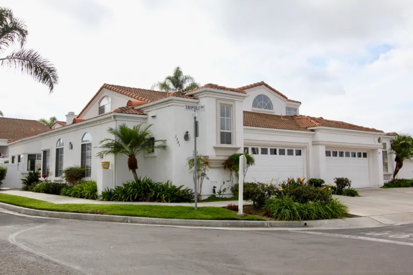 Two story white home on a corner in Oceanside CA at Villa Trieste