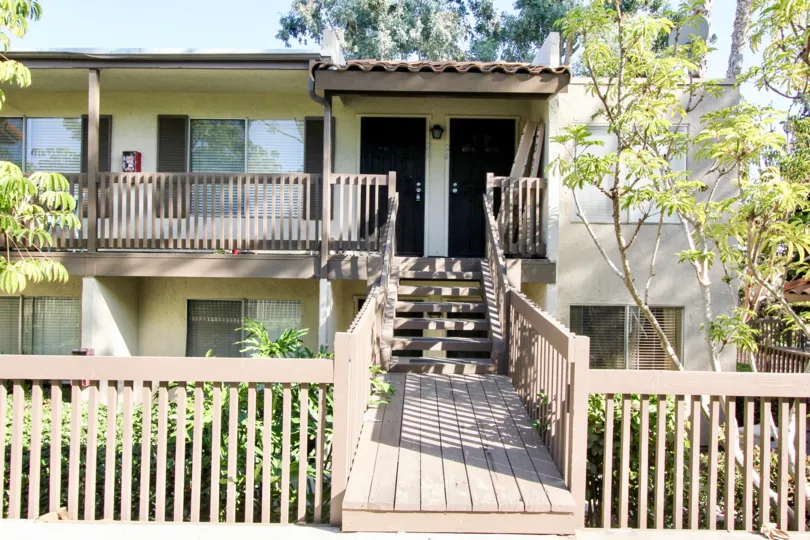 The sun shines down on a front porch and outdoor plants in Vine Villas, of the Californian city Oceanside.