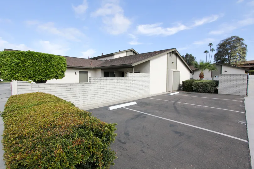 A brick wall in front in between a house and driveway in Vista de Oceana, Oceanside CA