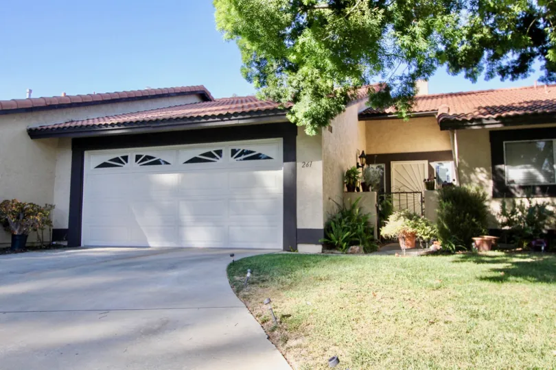 A sunny day in the Vista Montana wityh a garden and white doors at Oceanside in california
