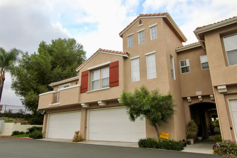 A two story property with two garages and an arched entryway at Vista Monte