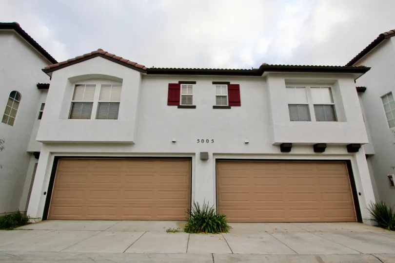Gorgeous white stone walls and red shudders with attached garages at Vista Monte.