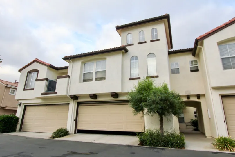 A garage door sits partially open on a townhouse at Vista Monte