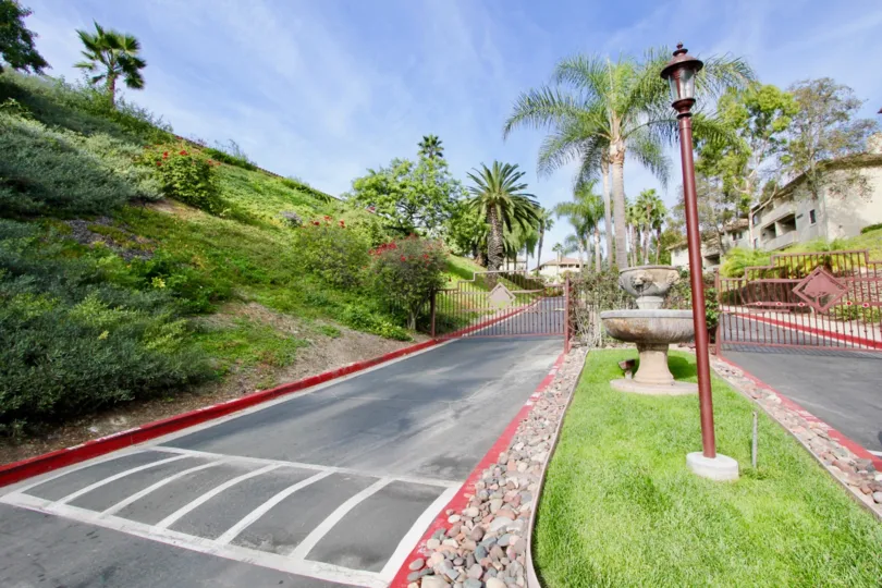 Gated entranceways with landscaped median with designer street lamps at the Vista Way Village in Oceanside, CA