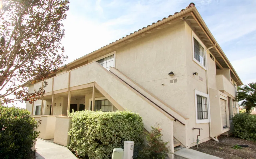 Side view of a house in the Vista Way Village community on a sunny day
