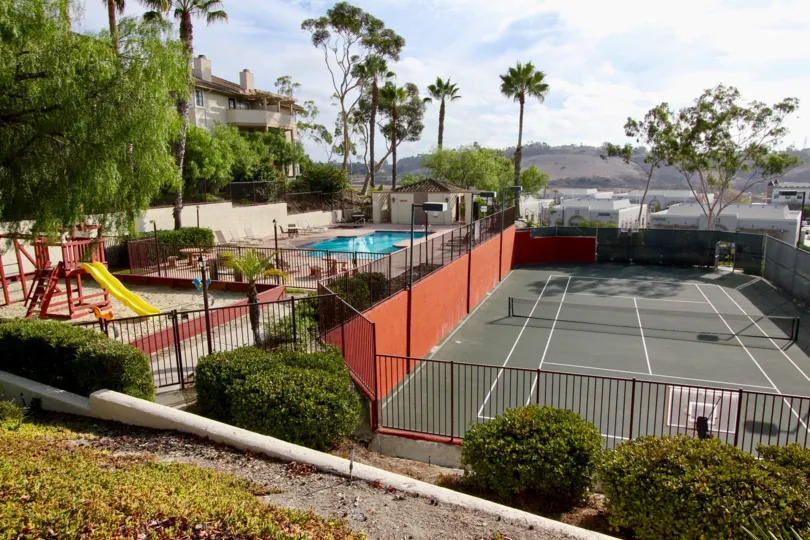 Tennis court, swimming pool and playground all fenced in for residents at Vista Way Village