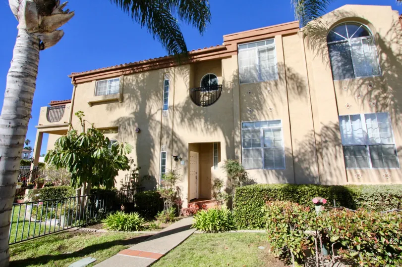 Two story pink condos with a yard in Oceanside CA at Wind & sea townhomes