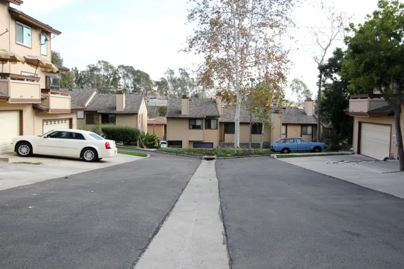 Front view of the compound with cars parked in front of the building in Woodlands Ivy