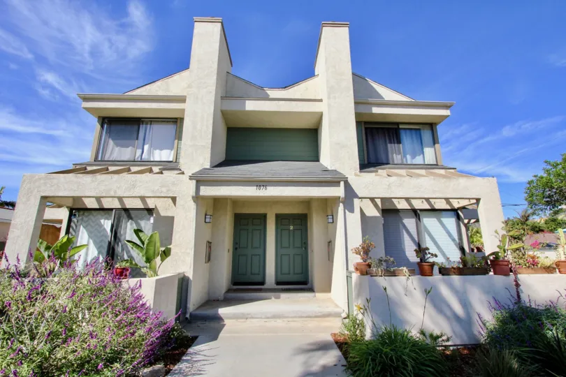 Two blue doors on the front of a connection condominium building at 1076 Opal in Pacific Beach CA