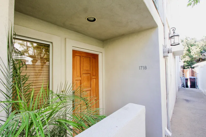 A sunny day in the area of 1718 Diamond, condo, wooden door, window, sidewalk, porch light