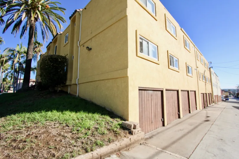 A sunny day in the area of 1915 Emerald, condos, garages, parking lot, palm trees