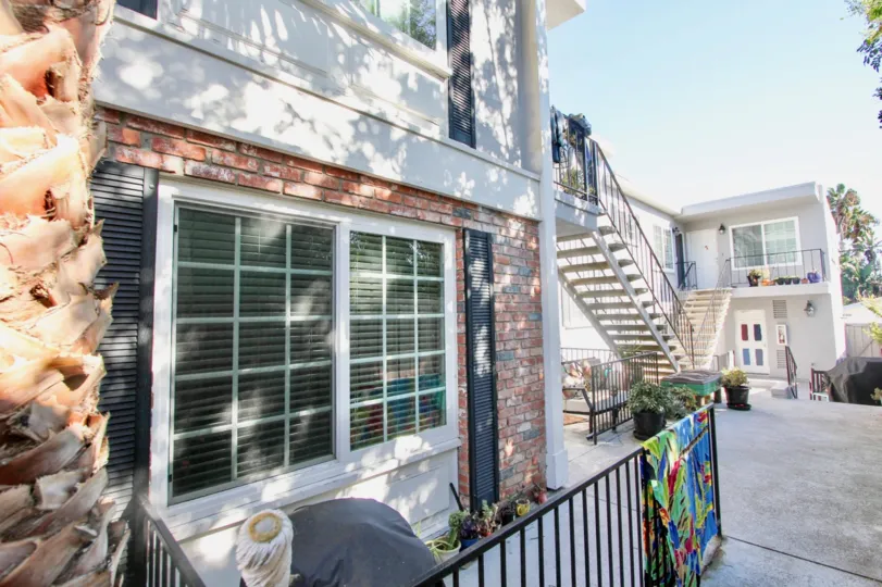 view of a house in 839 Sapphire with some trees and stairs along the black fencing