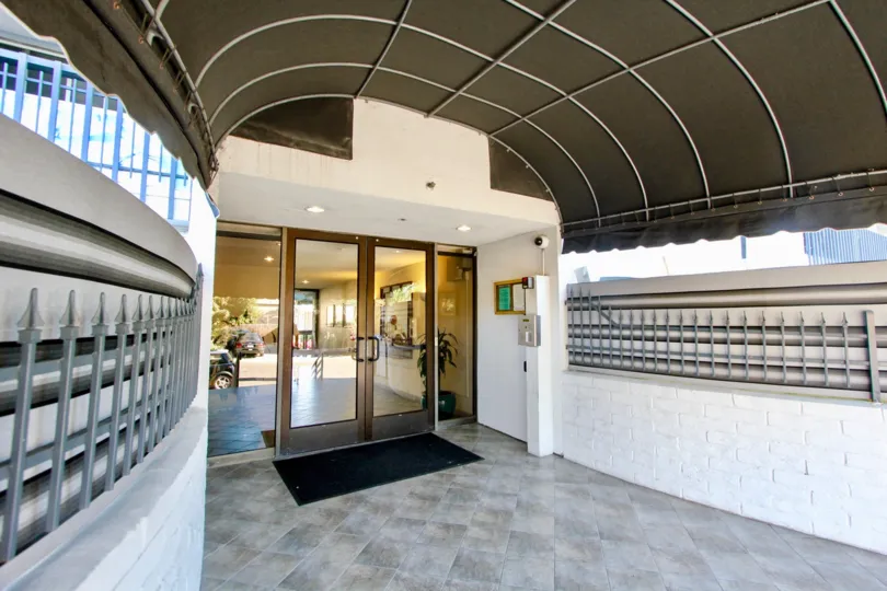 A marble tiled walkway leading to Barrier Reef community in Pacific Beach CA