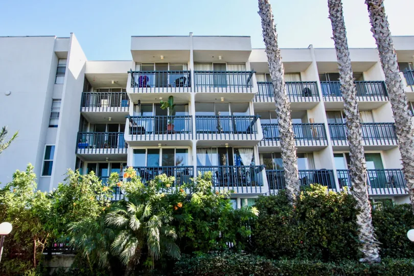 A low-rise contemporary housing in Barrier Reef community with blue terraces.