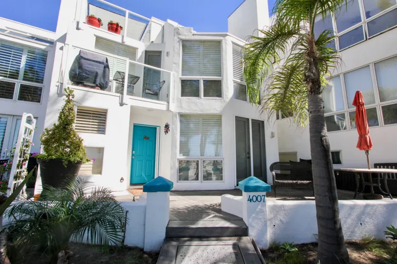 Beautiful Entrance view of villas on a sunny day with trees in Bay Contempo of Pacific Beach