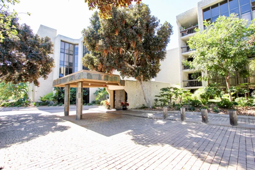 A sunny day in the area of Bay Scene, Condo, entrancem brick, trees, windows