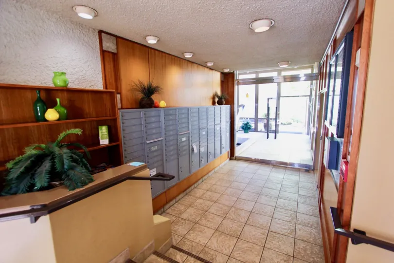 Entrance foyer/lobby with tile floors and wood paneling on walls with glass doors at Bay Scene