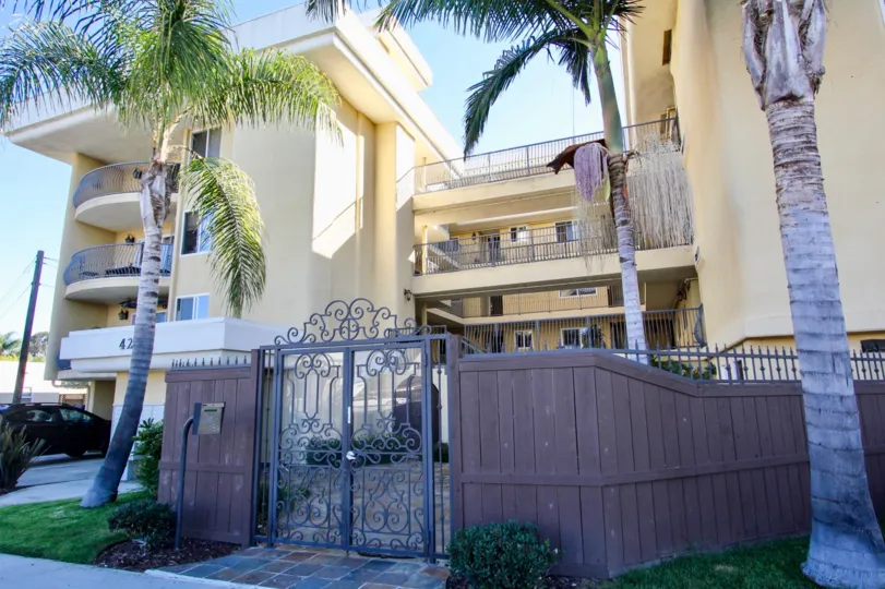 A sunny day in the area of Bayview Condos, outside, palm trees, gate, fence, car