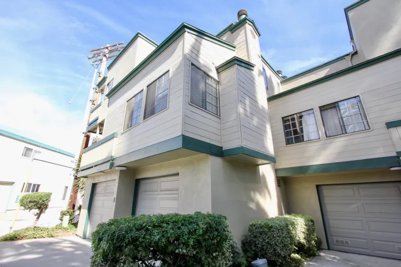 A sunny day in the area of Beach Scene, outside, garages, bushes, windows, condos