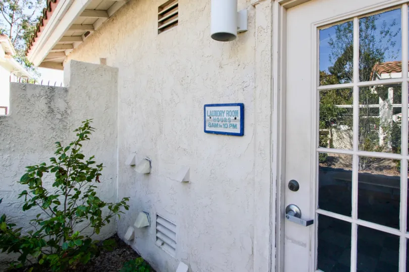 entrance view to a laundry room in Bella Pacific CA with a sighn board