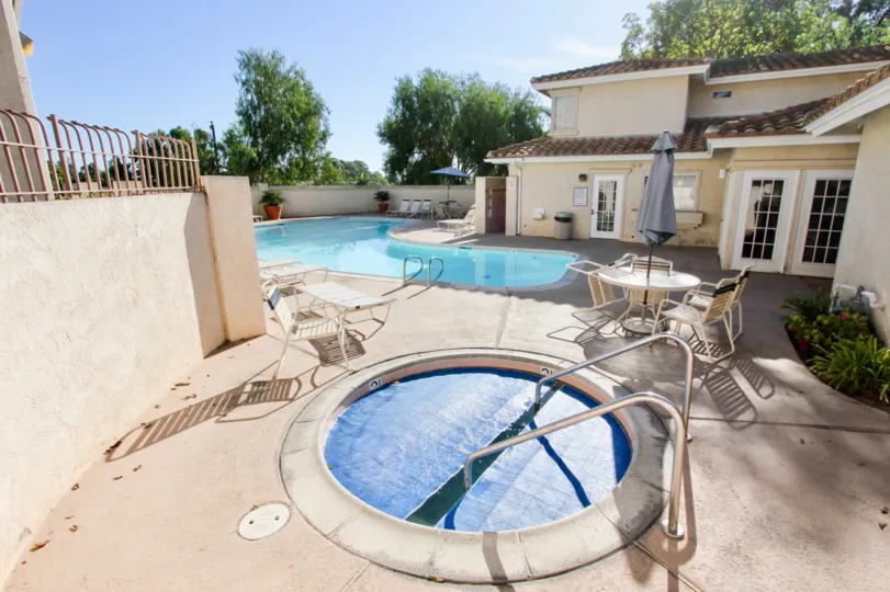 a sunny day in the bella pacific with a resort that has swiming pool and relaxing table
