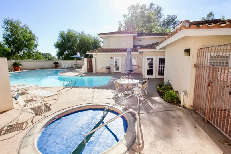 In the Apartment of Bella Pacific has both child and adults swimming pool with chairs and dining tables