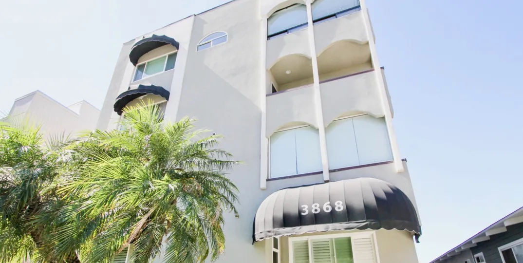 Beautiful California building with palm trees and black shaders