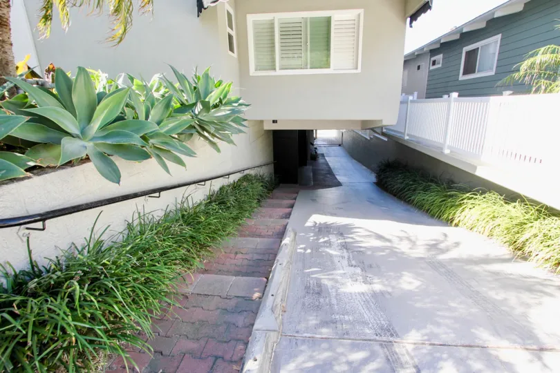 A sunny day in the area of Carmel Cove, outside, walkway, railing, stairs, grassck