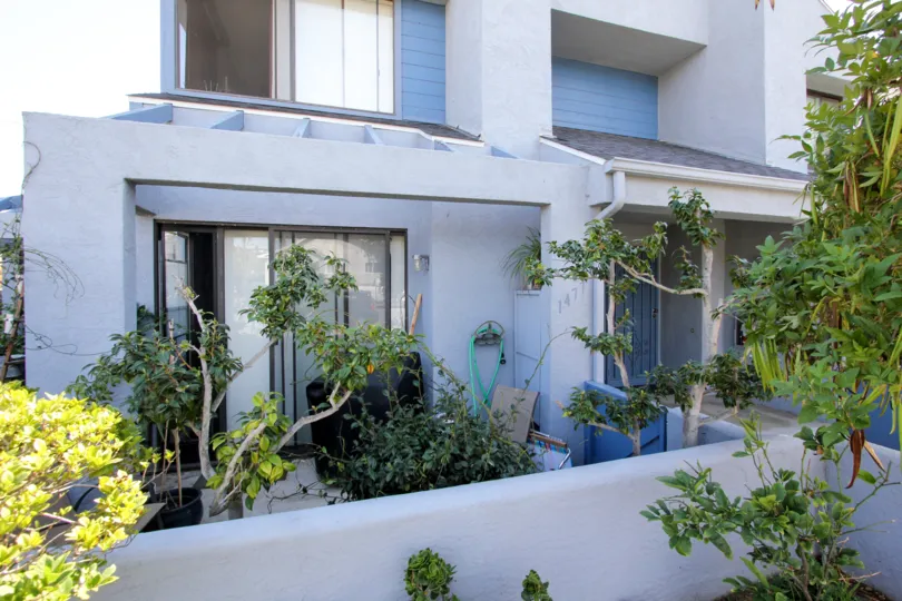 A TERRACE VIEW OF A HOUSE WITH GREEN TREES IN CHALCEDONY SIX