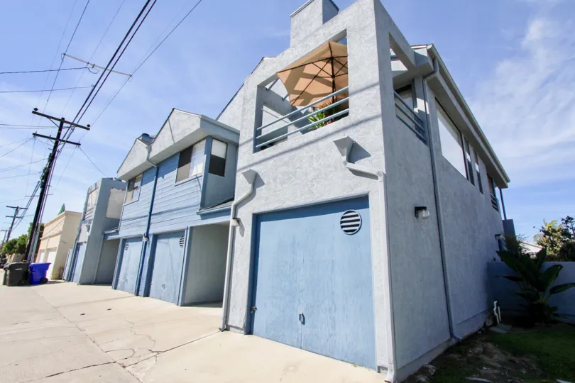 A contemporary low-rise residence in Chalcedony Six community painted in blue and gray.