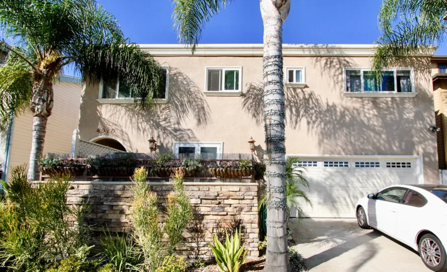 A sunny day in the area of Crown Morrell, outside, car, garage, palm trees, windows, condo