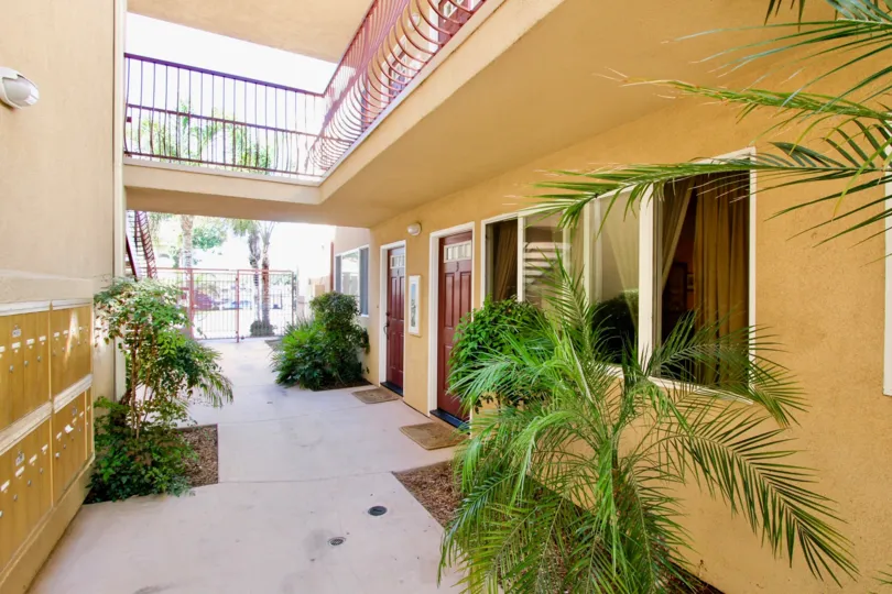 view from a housing with doors and second floor in view with red railings