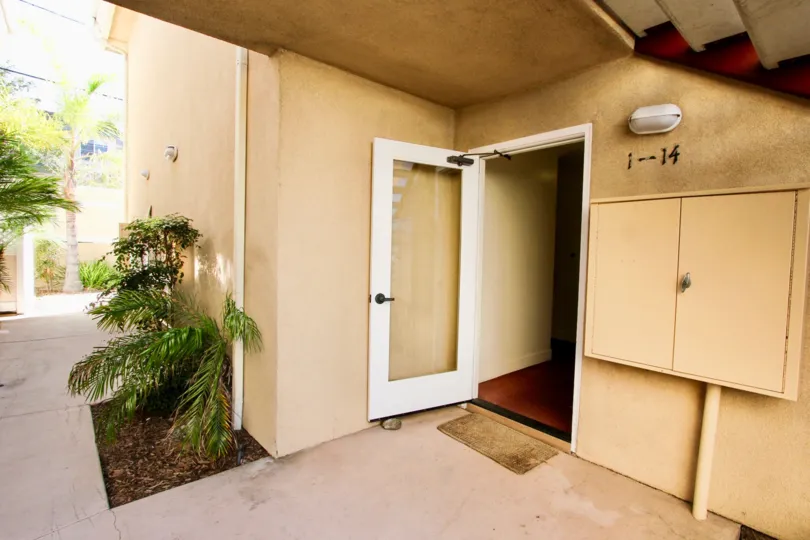A residence painted in yellowish color and with an open front door in the Crown Point Jewell community.