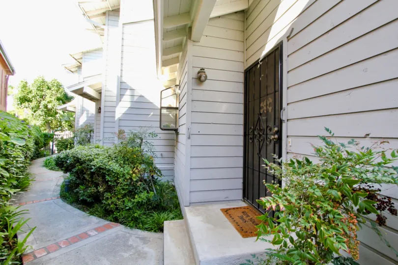 An entryway to townhouses in the Diamond by the Bay community with wood cladding.