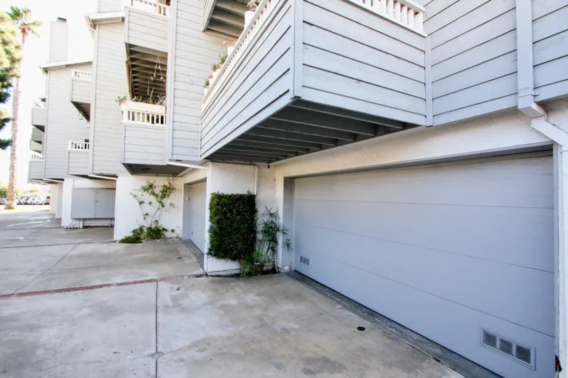 A shady area near a white colored apartment home setting.