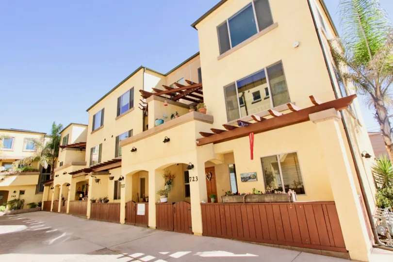 A sunny day some apartments in the Diamond Pointe at the Ocean with some wooden gate.