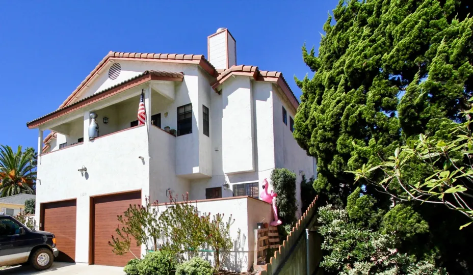 THE HOUSE IN THE ELITE TOWNHOMES WITH THE CAR PARKING, NATIONAL FLAG, UPSTAIRS