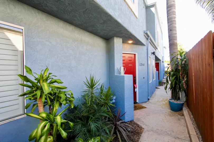 THE 1266 APARTMENT IN THE FELSPAR CONDOS WITH THE FLOWER POT, PLANTS, PATHWAY, WOODEN WALL