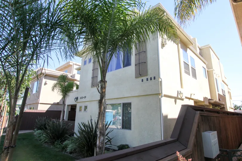 A shady backyard view of the Felspar Townhomes in Pacific Beach