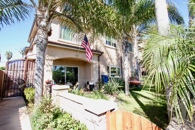 Multi-story apartment complex with gated access and private backyards in Pacific Beach, California