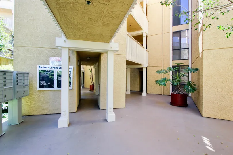 A sunny day in the area of Gresham La Palms, mailboxes, potted plant, lobby, doorway, windows