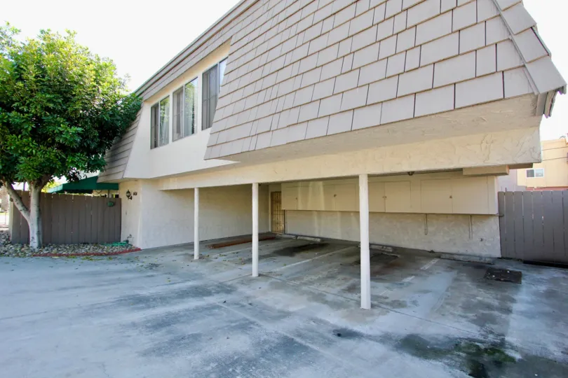 An empty parking space in the La Casa Villa community with tile roofing.