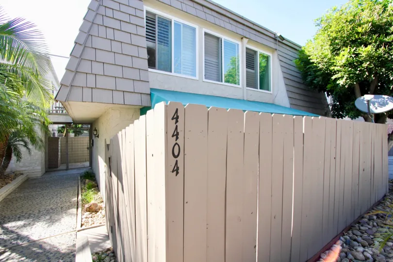 a sunny day in the la casa villa with ahouse that has wooden compound.