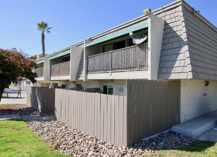 A two-storey residence with gray roofing and fence in La Casa Villa community.